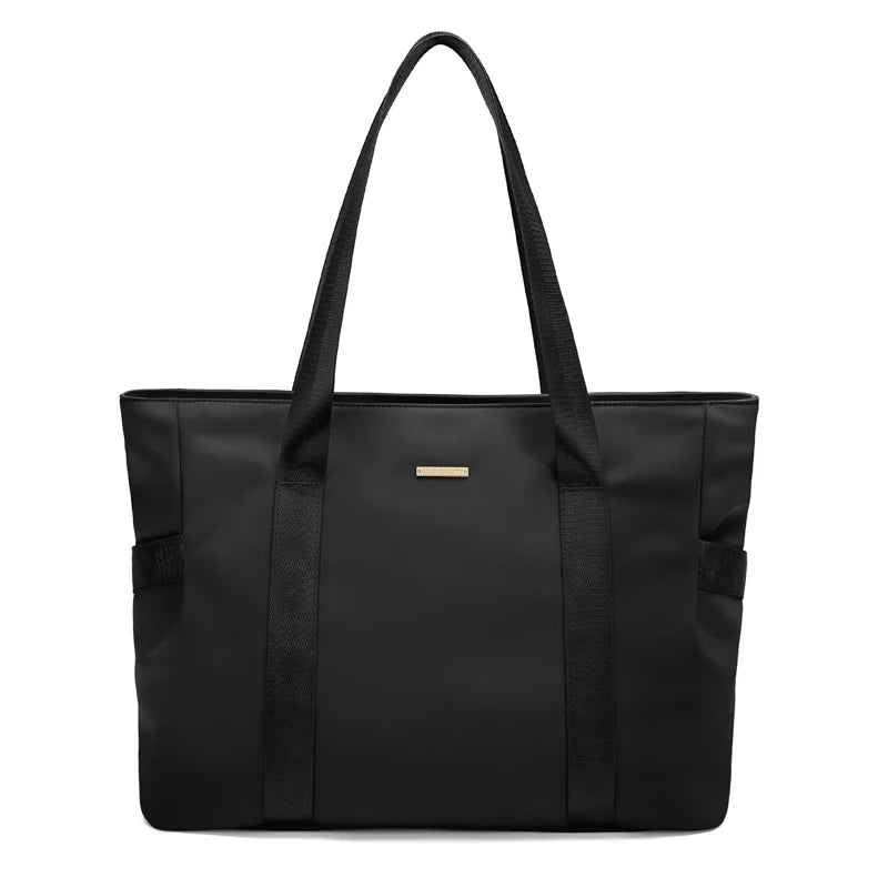 Black tote bag with a visible brand logo on a white background