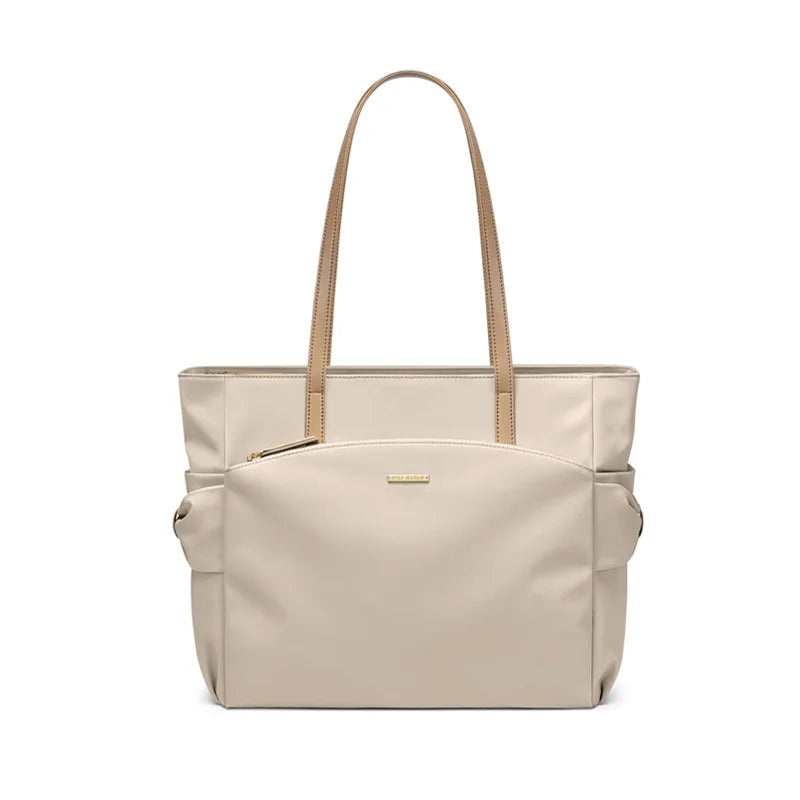 Beige tote bag with brown handles on a white background