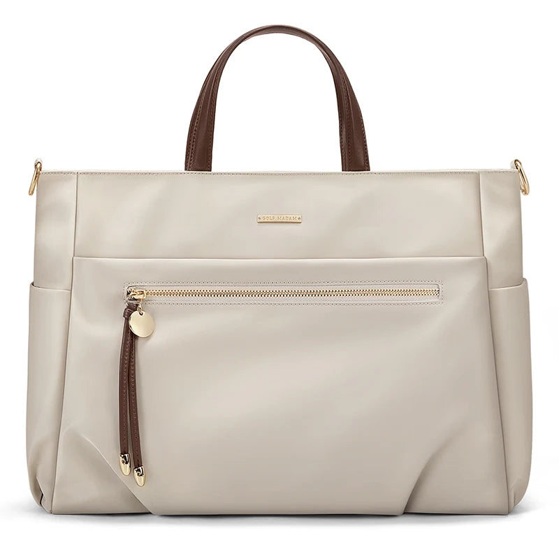 Beige handbag with brown handles and accents on a white background